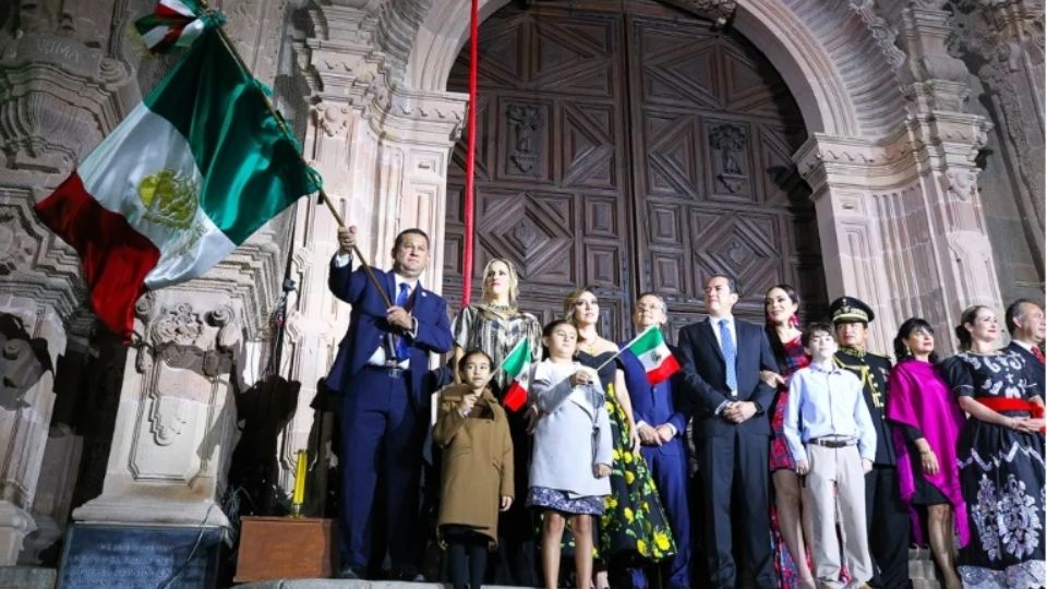 Después de dar El Grito, Diego Sinhue ondeó la bandera,entre el repique de campanas de la Parroquia de Nuestra Señora de los Dolores.