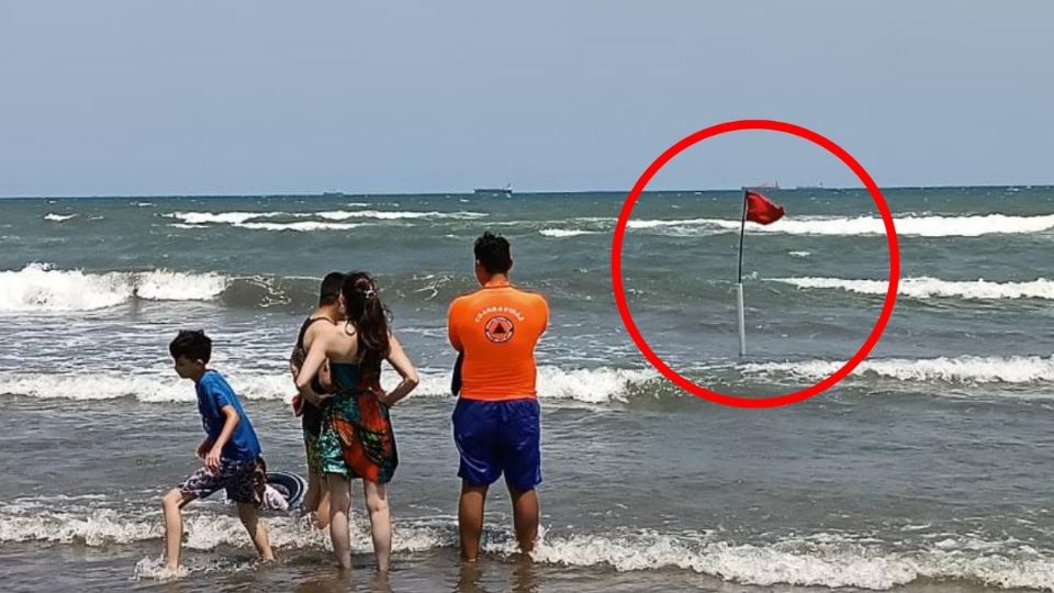 Para advertir a los turistas de las condiciones de peligro en la playa, por el frente frío.