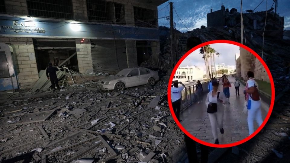 Los palestinos inspeccionan los alrededores destruidos de la Torre Palestina después de que aviones de combate israelíes la atacaran en la ciudad de Gaza.