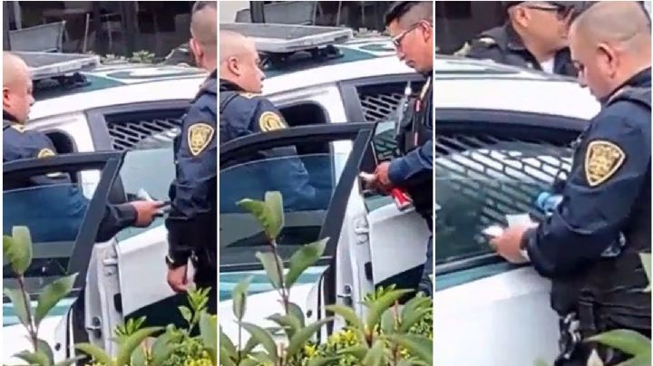 Policías de la CDMX son captados en video repartiendo fajos de dinero